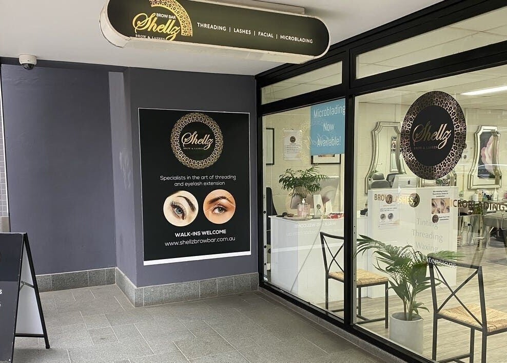 Entrance of Shellz Brow Bar in Melbourne, Victoria, AU with signage for threading and lashes.