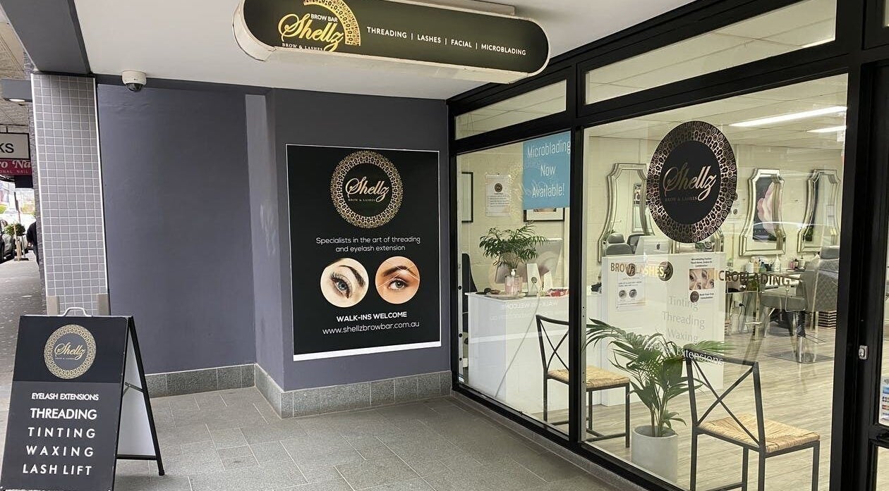 Entrance of Shellz Brow Bar in Melbourne, Victoria, AU with signage for threading and lashes.