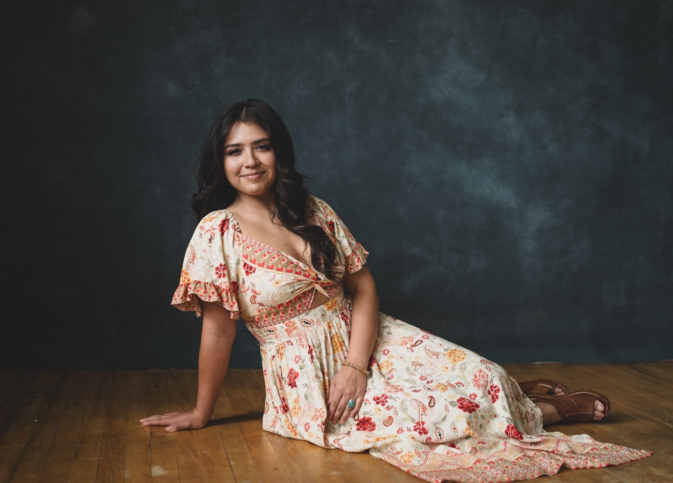 Woman in floral dress at Pura Vida Salon, Livingston, Montana, US.