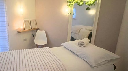 Relaxing massage room at Sophia's Studio Massage and Beauty in Woodley, England, GB, with soft lighting and decor.
