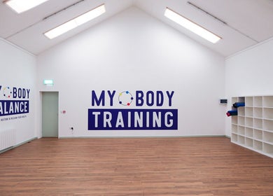 Spacious training room at Body Motion Pain and Injury Clinic in Drogheda, IE with wooden floors and bright lighting.