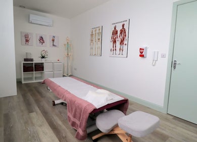 Therapy room at Myobody Balance in Drogheda, County Louth, IE with massage table and anatomy charts.