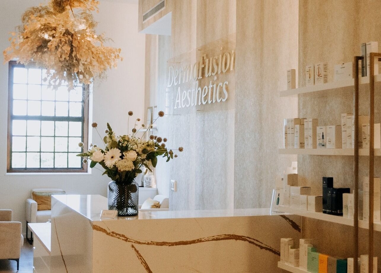 Elegant reception area at Dermafusion Aesthetics, Stellenbosch, Western Cape, ZA with neutral tones and floral decor.