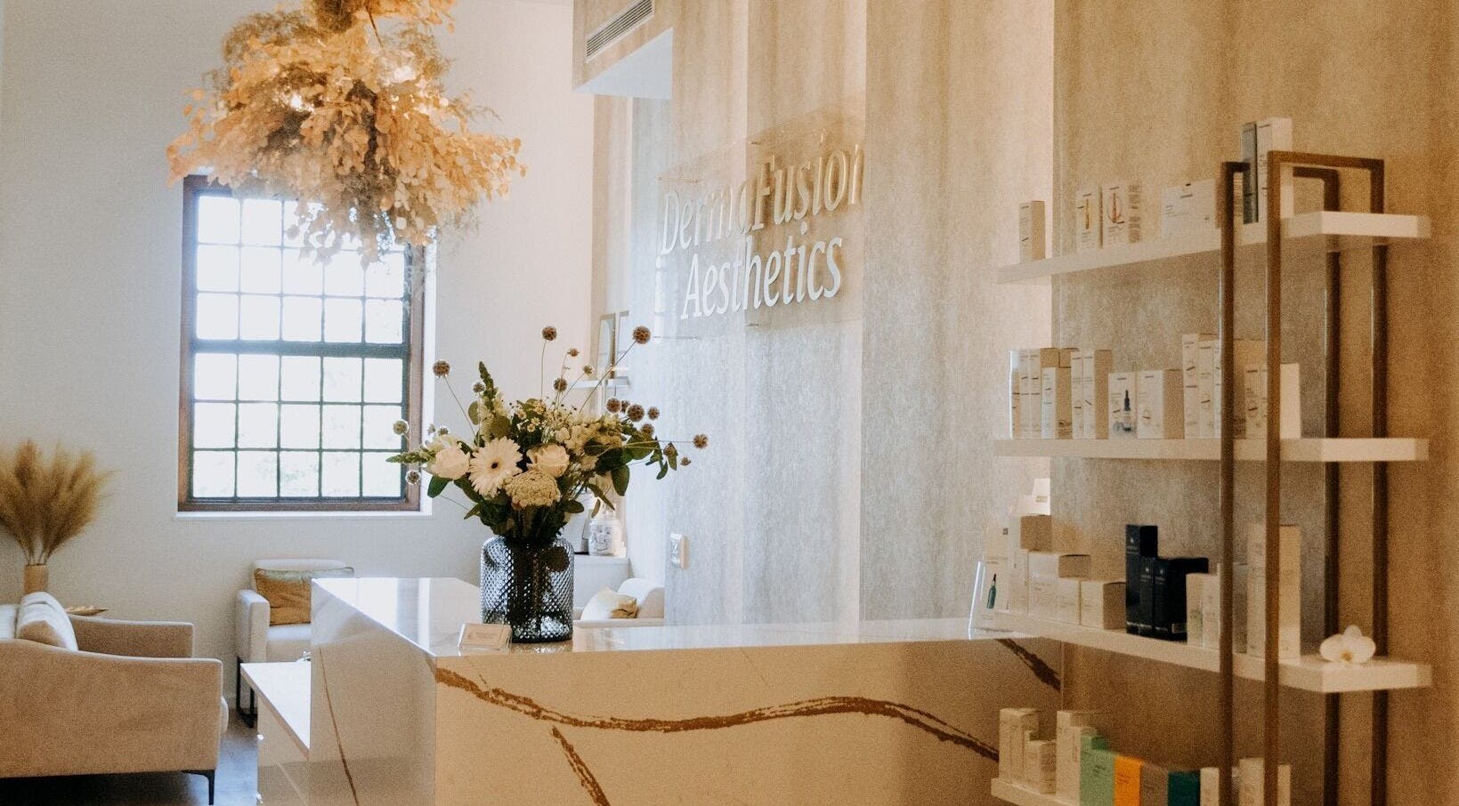 Elegant reception area at Dermafusion Aesthetics, Stellenbosch, Western Cape, ZA with neutral tones and floral decor.