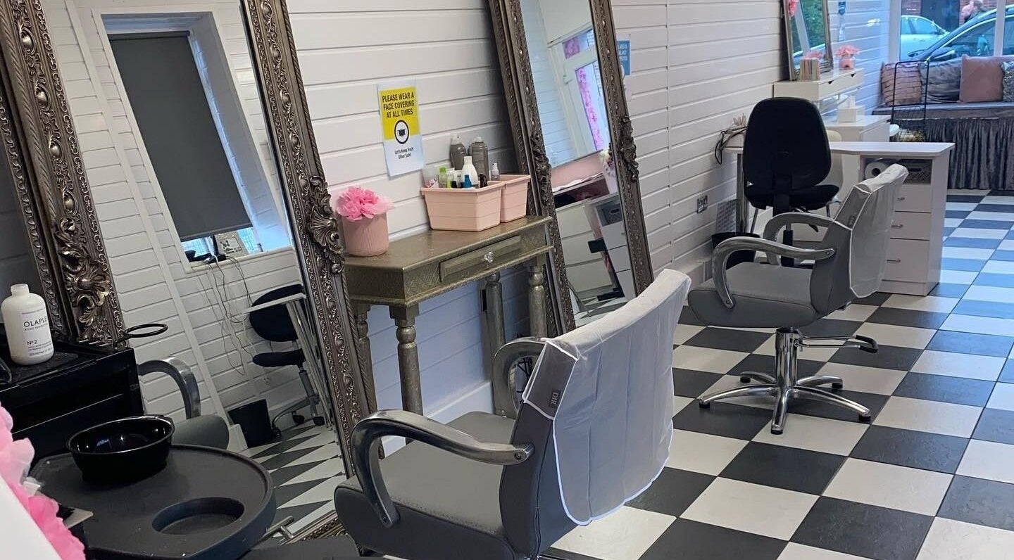 Stylish salon interior at Jessica Dolled Up, Crosby, England, GB, featuring chic chairs and ornate mirrors.