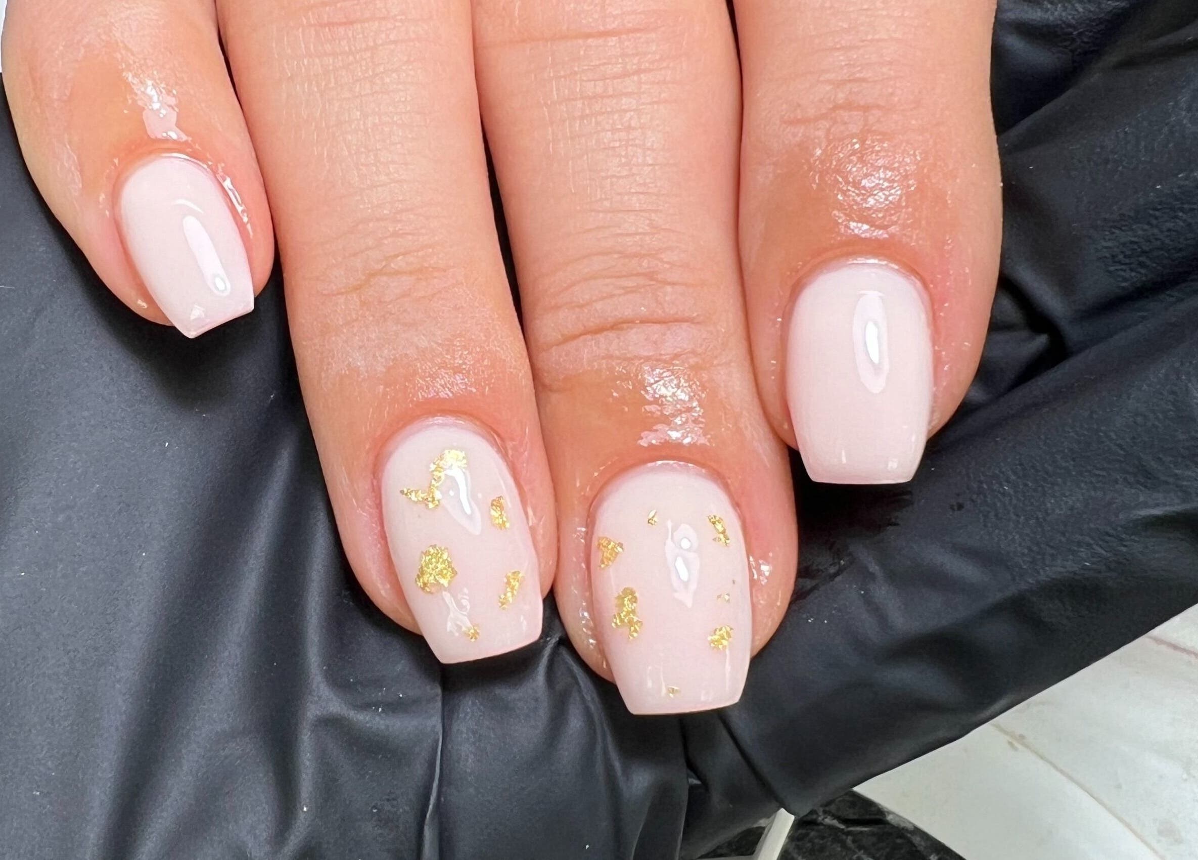 Elegant nude nails with gold accents at Moo Nails & Beauty, Exeter, England, GB.