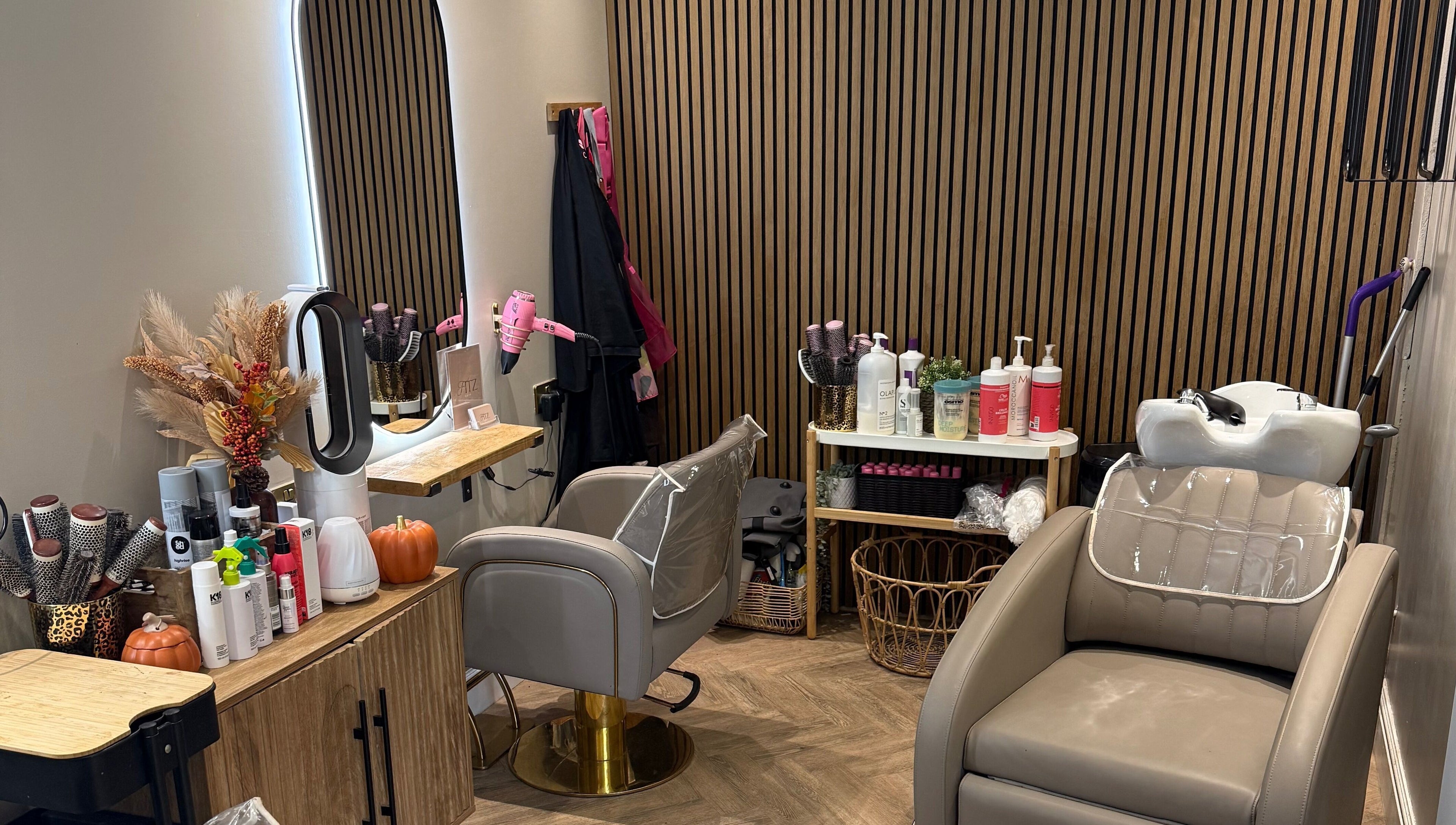 Elegant hairdressing station at Kate Fitzpatrick Hair, Deeside, Wales, GB, featuring styling tools and salon chair.