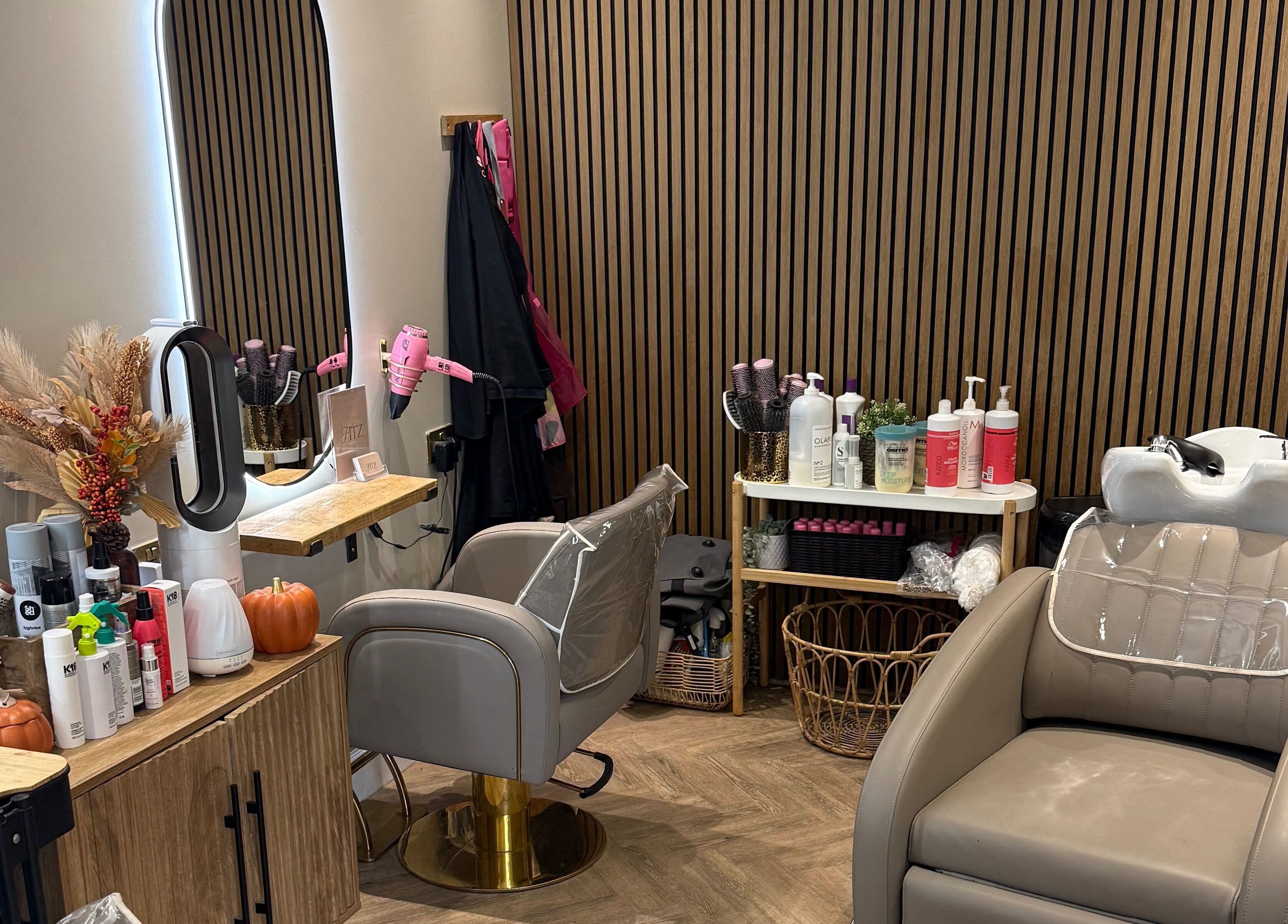 Elegant hairdressing station at Kate Fitzpatrick Hair, Deeside, Wales, GB, featuring styling tools and salon chair.