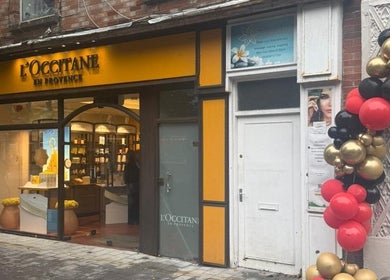 Elegant storefront of L'Occitane with colorful balloons at LBeauty, Limerick, County Limerick, IE.