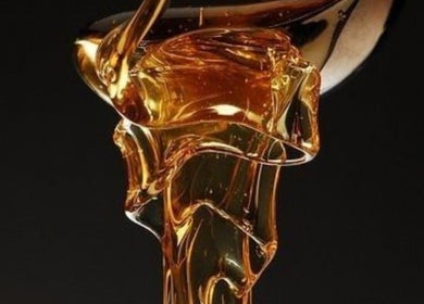 Golden honey dripping elegantly at LBeauty, Limerick, County Limerick, IE, symbolizing luxury wellness.