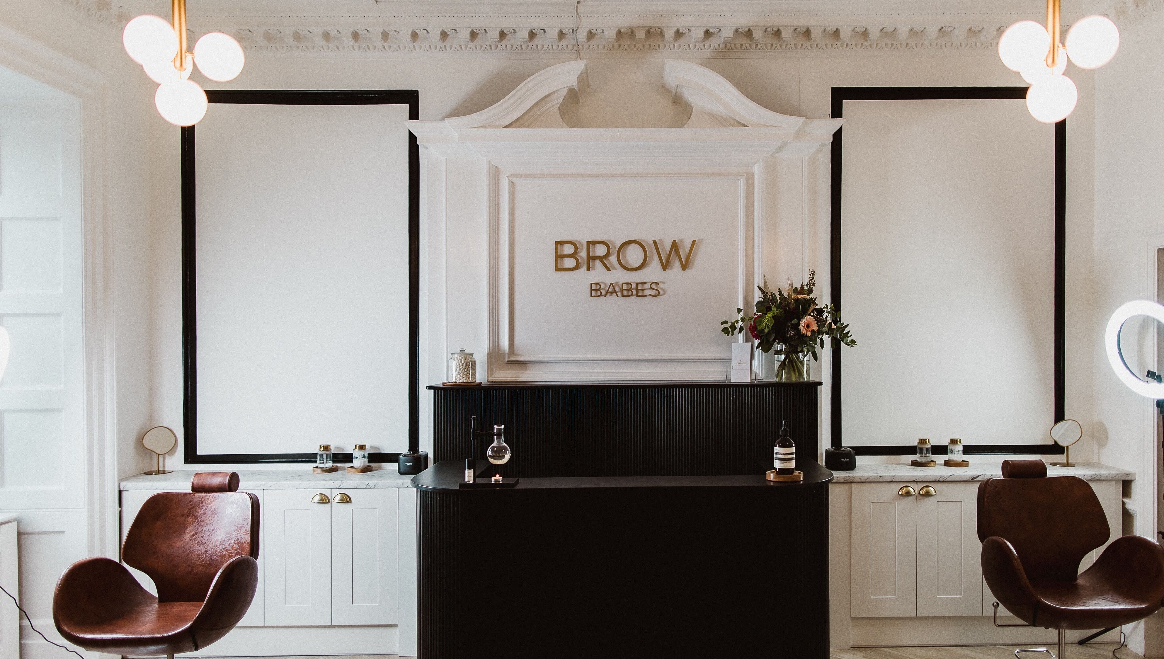 Elegant reception area at BROW BABES - PHOEBE in Truro, England, GB with stylish decor and leather chairs.
