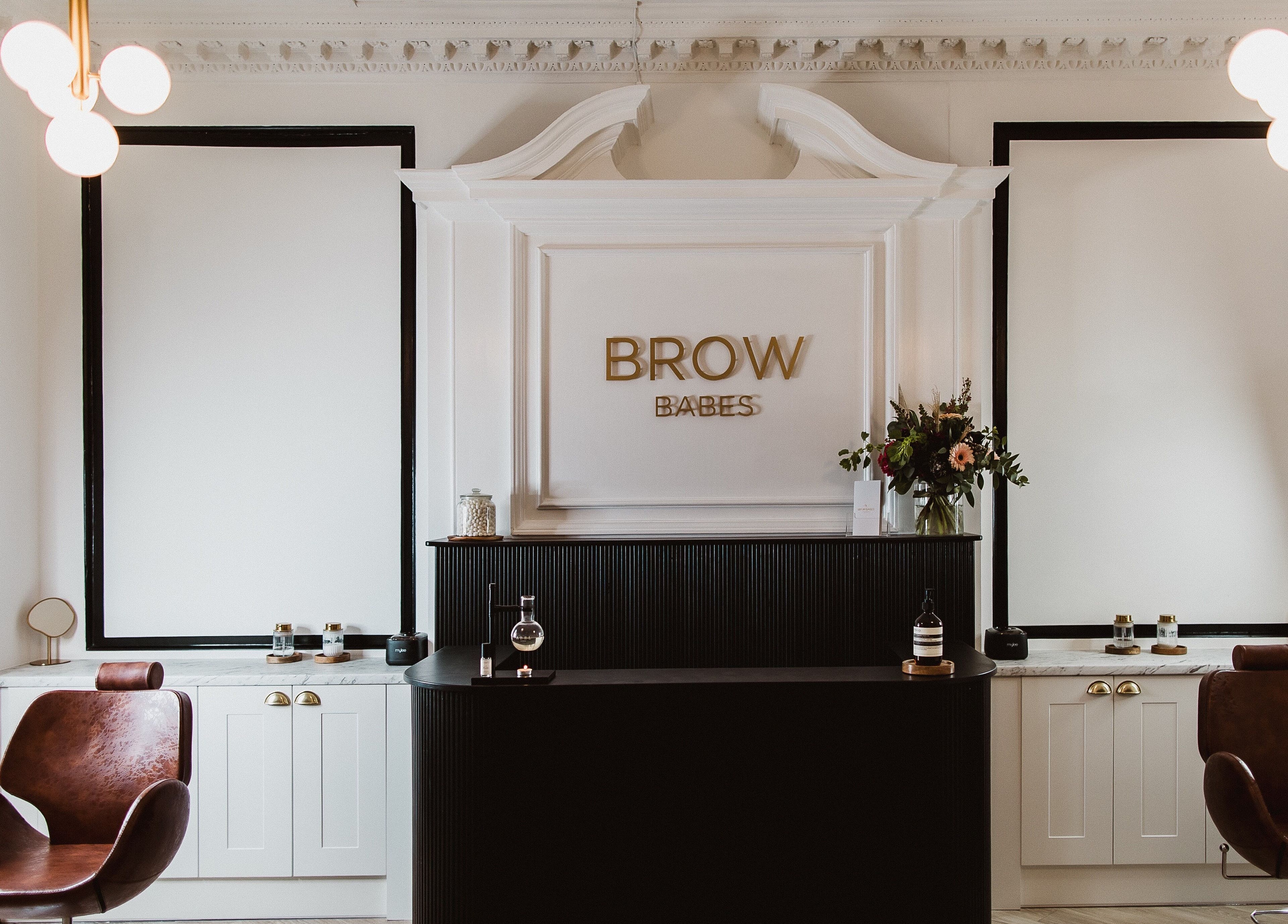 Elegant reception area at BROW BABES - PHOEBE in Truro, England, GB with stylish decor and leather chairs.