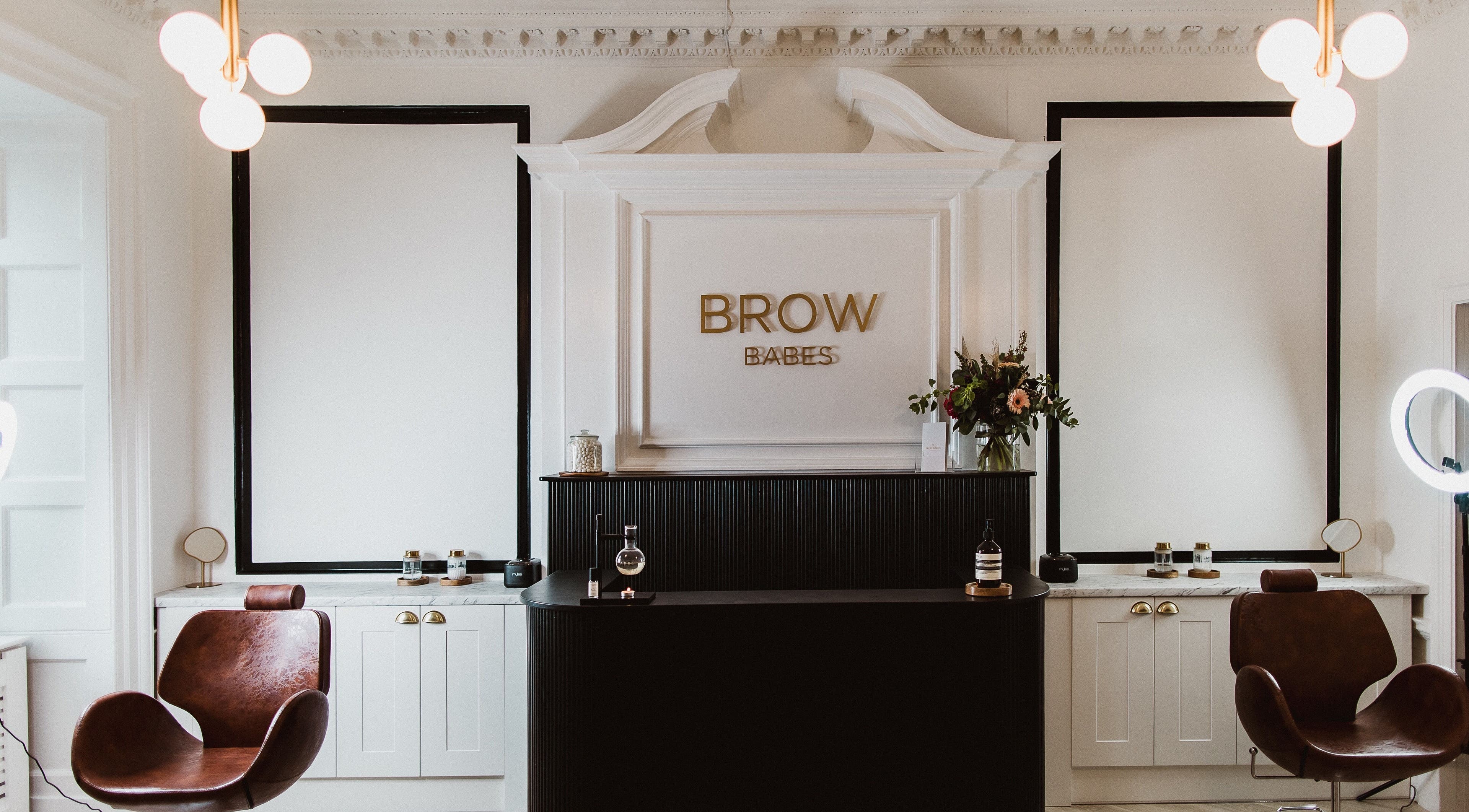 Elegant reception area at BROW BABES - PHOEBE in Truro, England, GB with stylish decor and leather chairs.