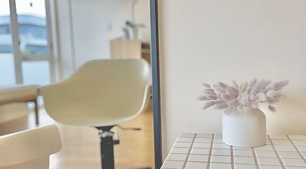 Modern chair and floral decor at Muse Hair Studio, Bay of Plenty, Bay of Plenty, NZ.