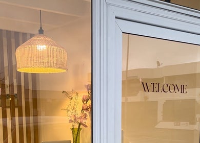 Entrance of Muse Hair Studio in Bay of Plenty, NZ, featuring welcoming decor and elegant lighting.