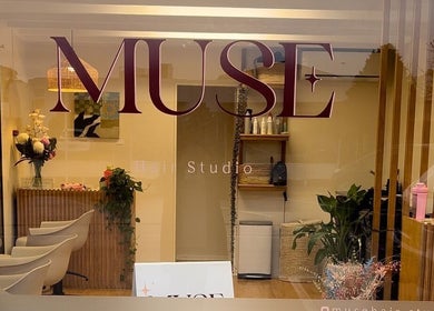 Entrance view of Muse Hair Studio in Bay of Plenty, NZ, showcasing elegant decor and inviting atmosphere.