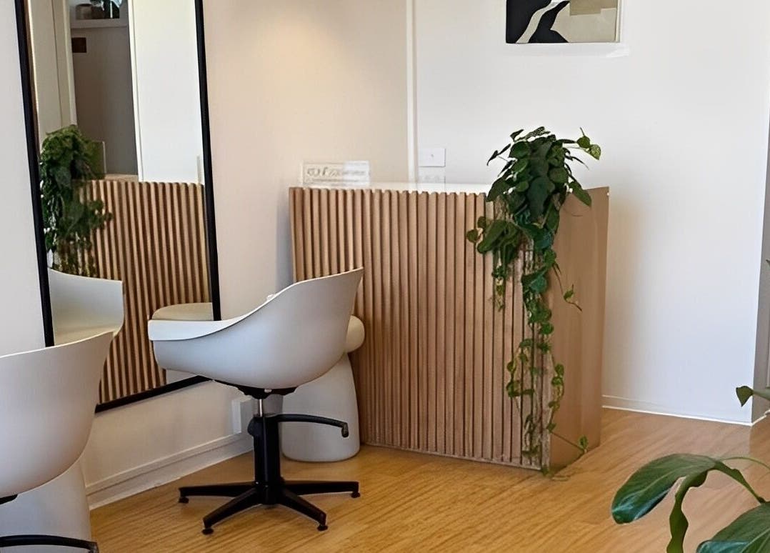 Modern, tranquil interior of Muse Hair Studio in Bay of Plenty, NZ, featuring sleek decor and lush plants.