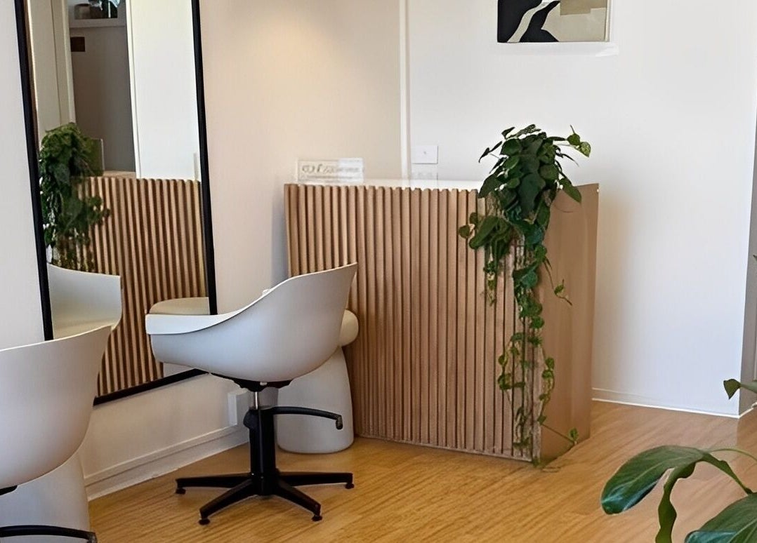 Modern, tranquil interior of Muse Hair Studio in Bay of Plenty, NZ, featuring sleek decor and lush plants.