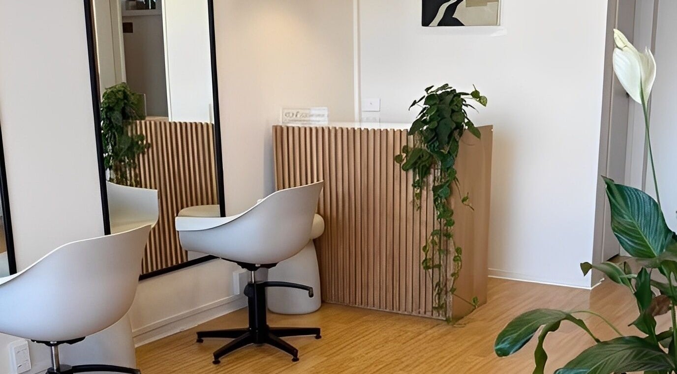 Modern, tranquil interior of Muse Hair Studio in Bay of Plenty, NZ, featuring sleek decor and lush plants.