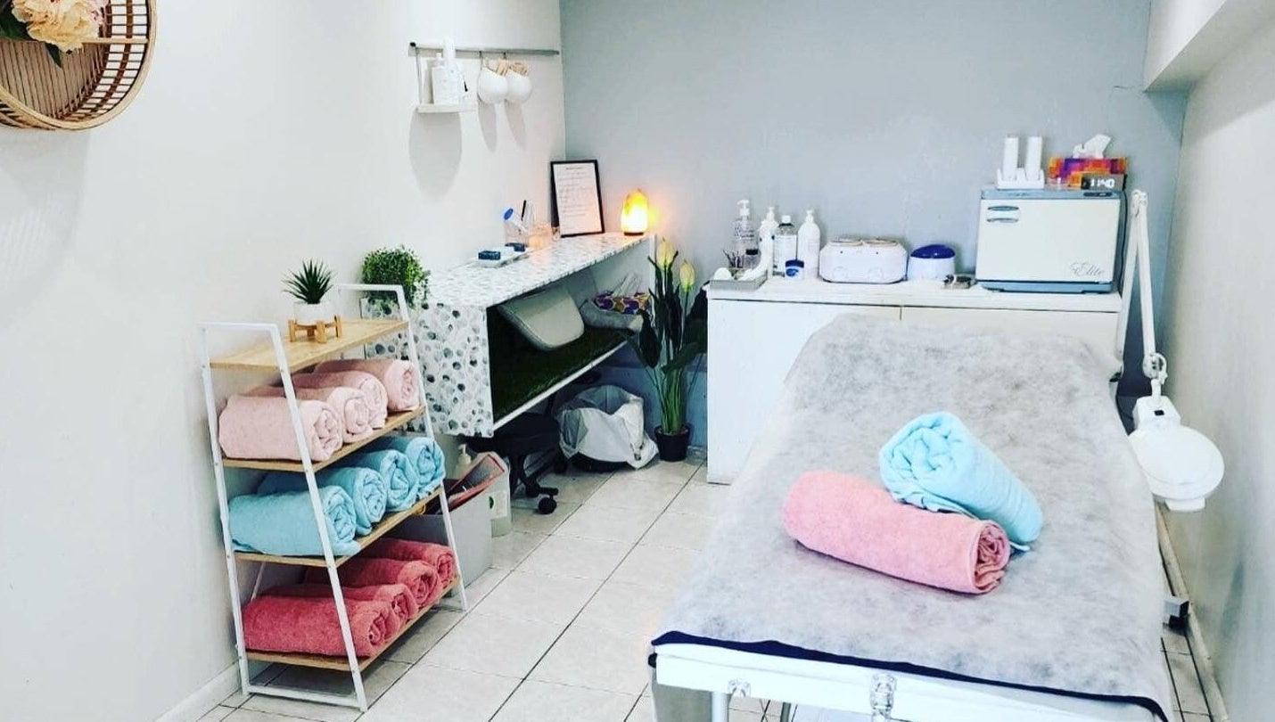 Tranquil treatment room at Gloss Beauty Salon in Prestons, New South Wales, AU, featuring cozy towels and decor.