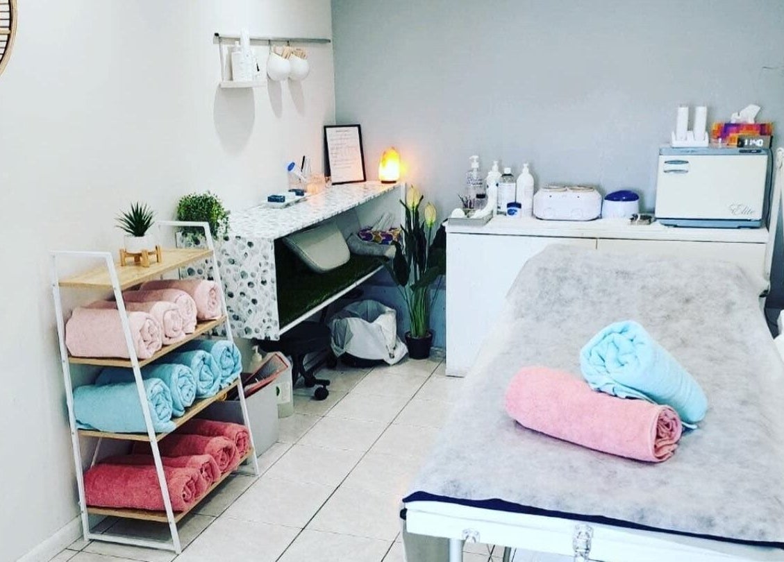 Tranquil treatment room at Gloss Beauty Salon in Prestons, New South Wales, AU, featuring cozy towels and decor.