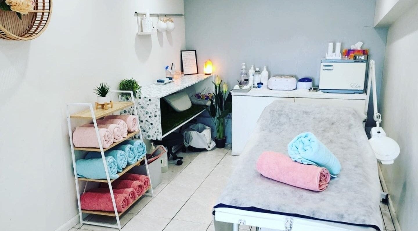 Tranquil treatment room at Gloss Beauty Salon in Prestons, New South Wales, AU, featuring cozy towels and decor.