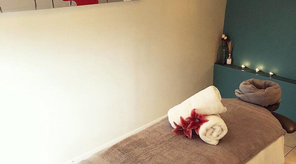 Relaxing massage room at Gloss Beauty Salon in Prestons, New South Wales, AU, with candles and soft towels.