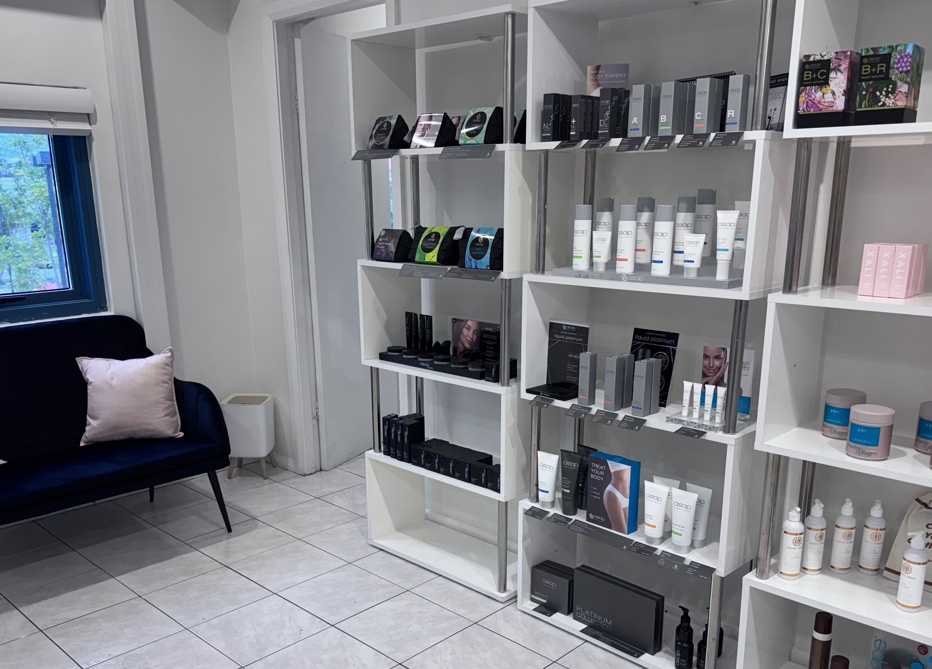 Product shelves in Gloss Beauty Salon, Prestons, New South Wales, AU showcasing premium skincare items.