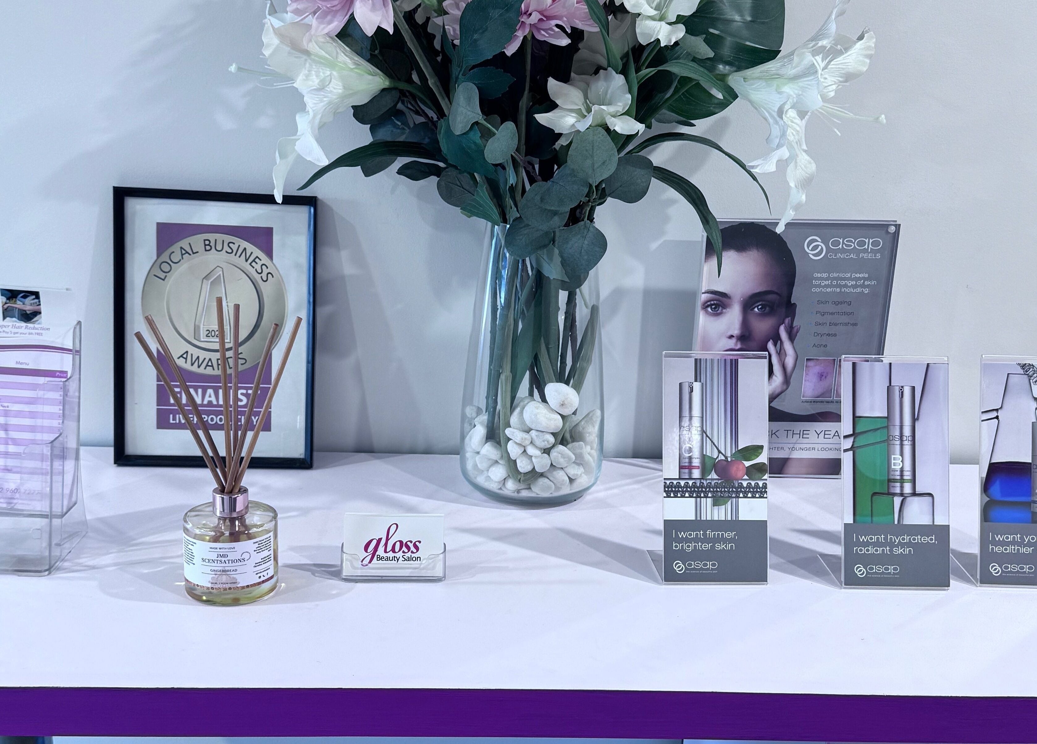 Gloss Beauty Salon reception decor with awards and skincare, Prestons, New South Wales, AU.