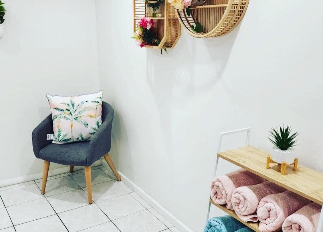 Cozy corner at Gloss Beauty Salon, Prestons, New South Wales, AU with plush seating and vibrant decor.