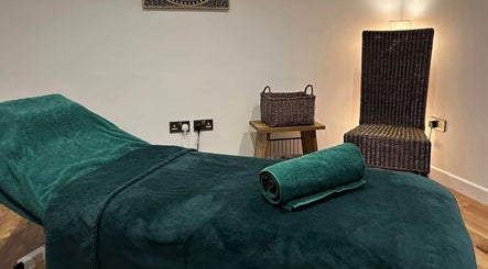 Relaxing therapy room at Orchard Holistic Therapy, Waterlooville, England, GB, featuring a green massage bed.