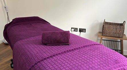 Relaxing massage room at Orchard Holistic Therapy, Waterlooville, England, GB, with a purple treatment table.