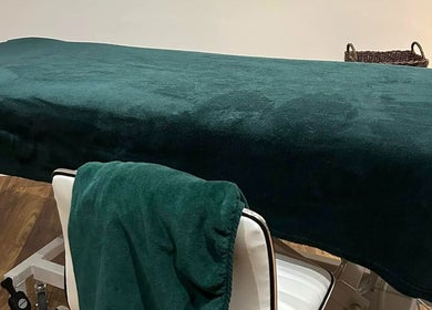 A serene massage table at Orchard Holistic Therapy, Waterlooville, England, GB, ready for relaxation.