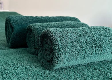 Luxurious green towels at Orchard Holistic Therapy in Waterlooville, England, GB. Perfect for a relaxing experience.