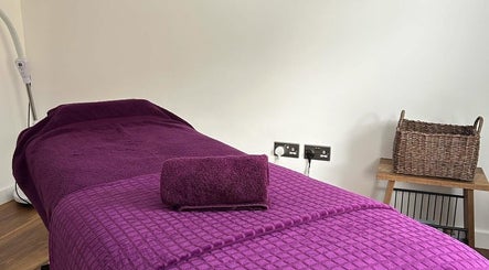 Relaxing massage bed setup with purple linens at Orchard Holistic Therapy, Waterlooville, England, GB.