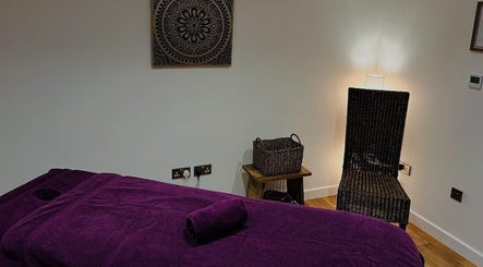 Relaxing therapy room at Orchard Holistic Therapy in Waterlooville, England, GB with a purple massage bed.