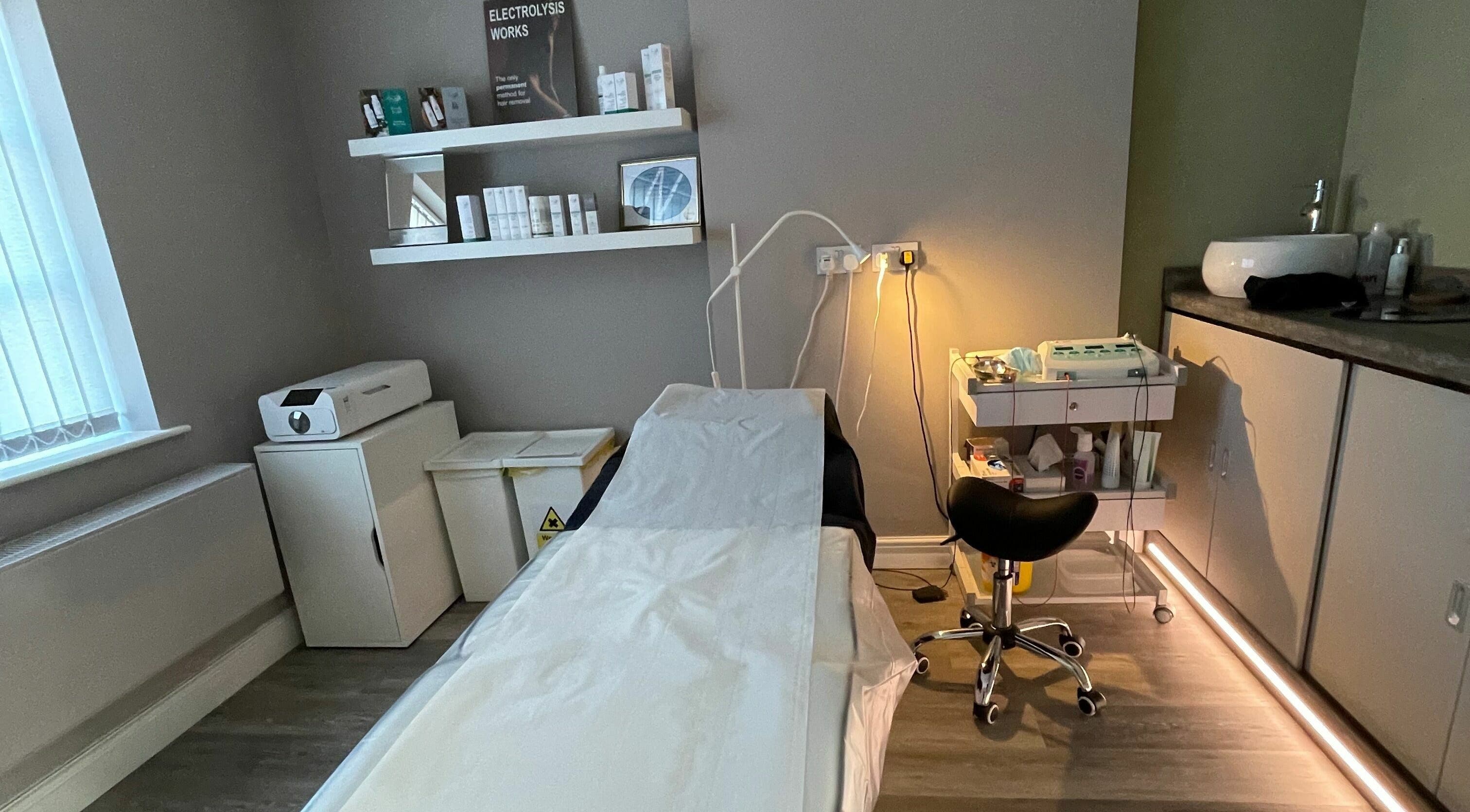 Cozy treatment room at Anagen Therapies, Swanland, England, GB, showcasing modern equipment and calming decor.