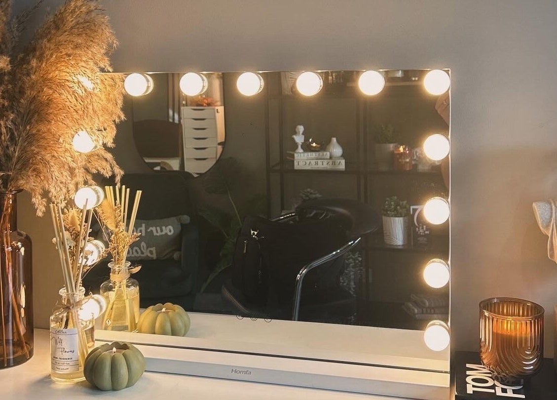 Chic vanity with lights at Eden By Elizabeth, Newton-le-Willows, England, GB. Stylish decor includes vase and bust.