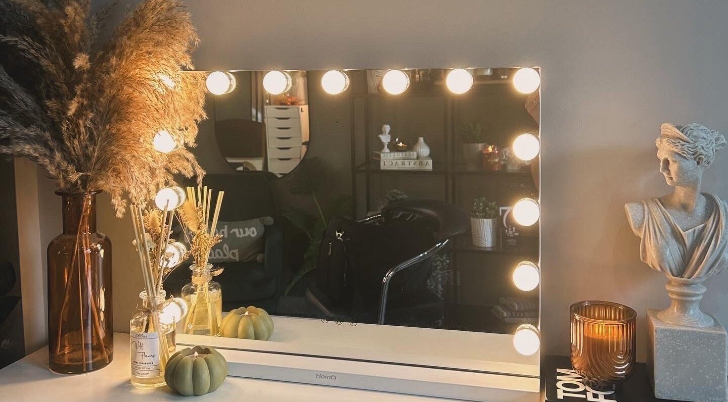 Chic vanity with lights at Eden By Elizabeth, Newton-le-Willows, England, GB. Stylish decor includes vase and bust.