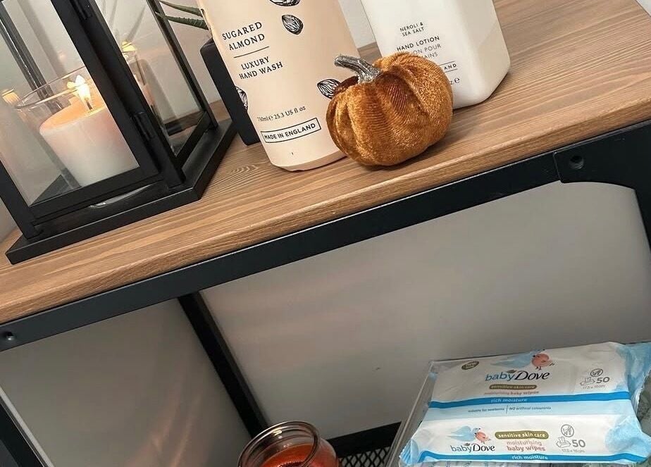 Chic shelf at Eden By Elizabeth, Newton-le-Willows, England, GB with luxury hand wash and candle for a cozy ambiance.