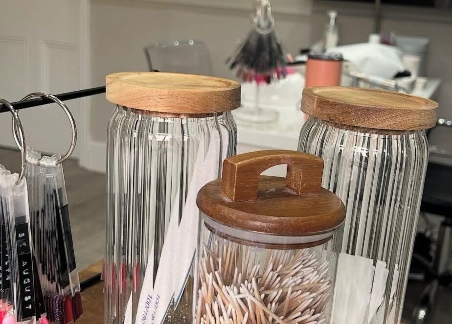 Elegant glass jars with beauty tools at Eden By Elizabeth, Newton-le-Willows, England, GB.