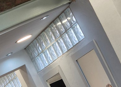 Stylish glass block wall at Associates Hair Winchester, Winchester, England, GB, enhancing the sleek interior.