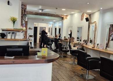 Interior of Associates Hair Winchester salon in Winchester, England, GB showing modern styling stations.