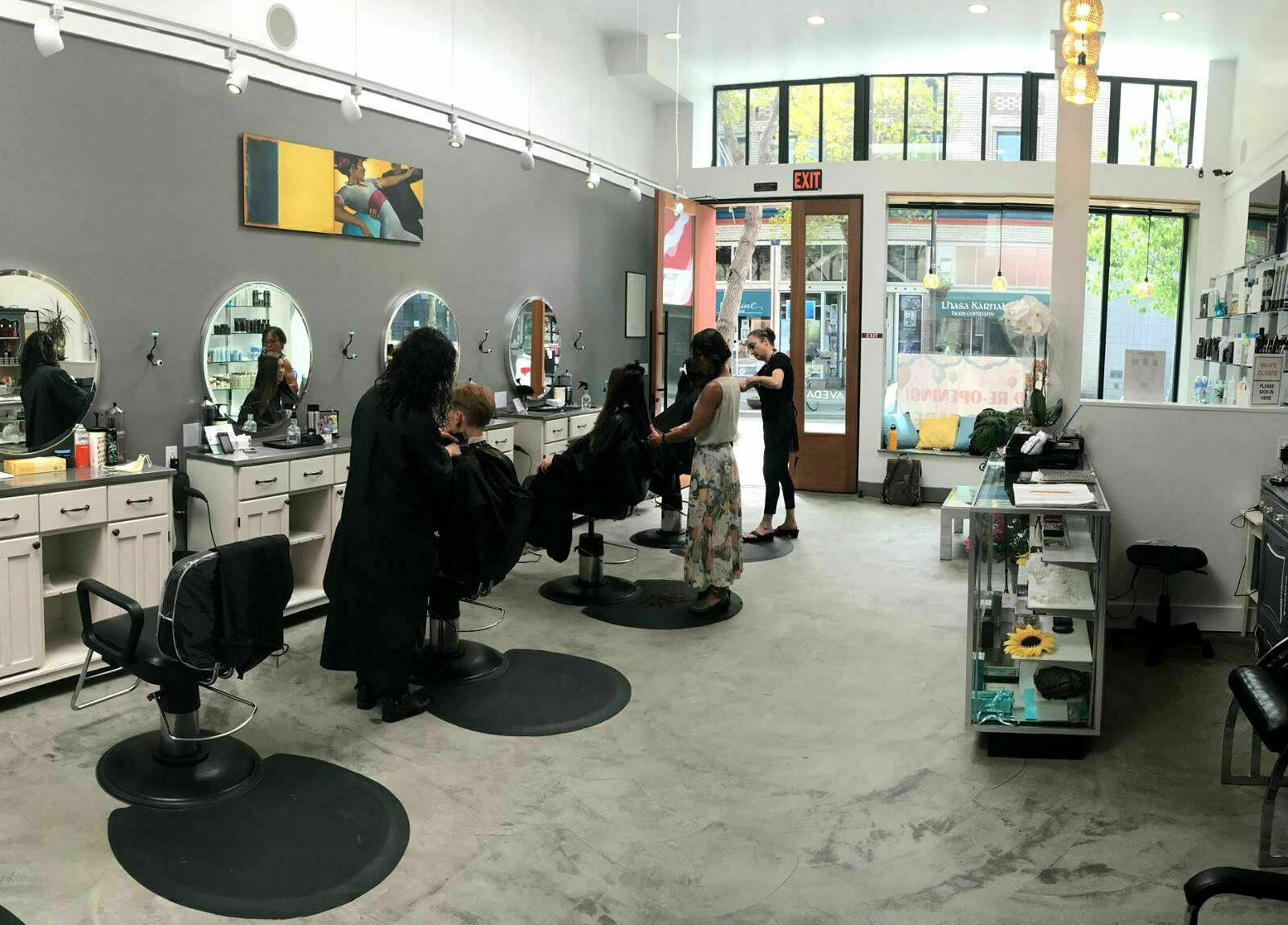 Inside view of Maxi Hair Salon in Berkeley, California, US, featuring modern styling stations and clients.