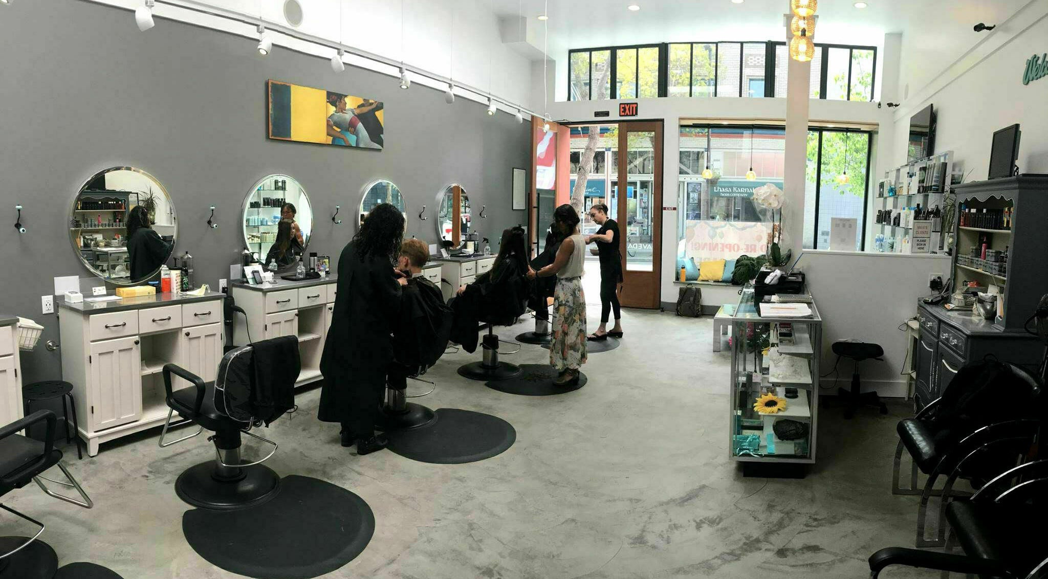 Inside view of Maxi Hair Salon in Berkeley, California, US, featuring modern styling stations and clients.