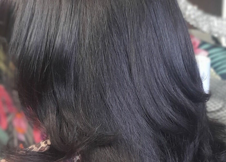 Silky black hairstyle at Elite Eight Barbering Co, Saint Stephen, England, GB.