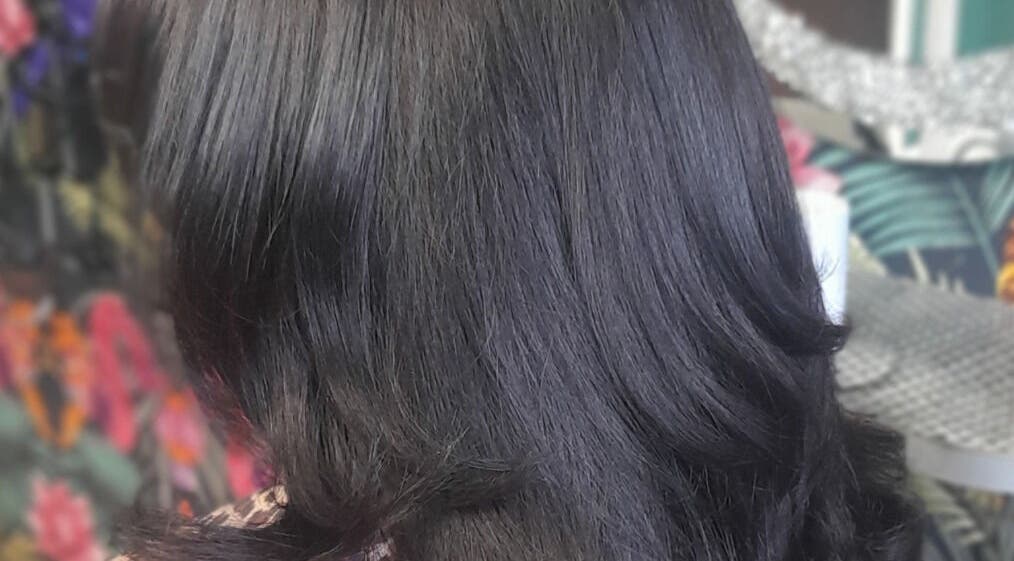 Silky black hairstyle at Elite Eight Barbering Co, Saint Stephen, England, GB.