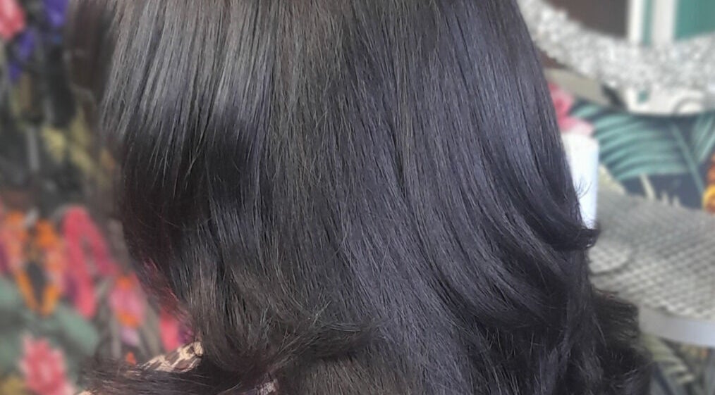 Silky black hairstyle at Elite Eight Barbering Co, Saint Stephen, England, GB.