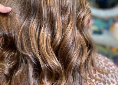 Stylish curled hair at Elite Eight Barbering Co, Saint Stephen, England, GB. Perfect blend of volume and shine.