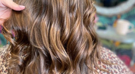 Stylish curled hair at Elite Eight Barbering Co, Saint Stephen, England, GB. Perfect blend of volume and shine.